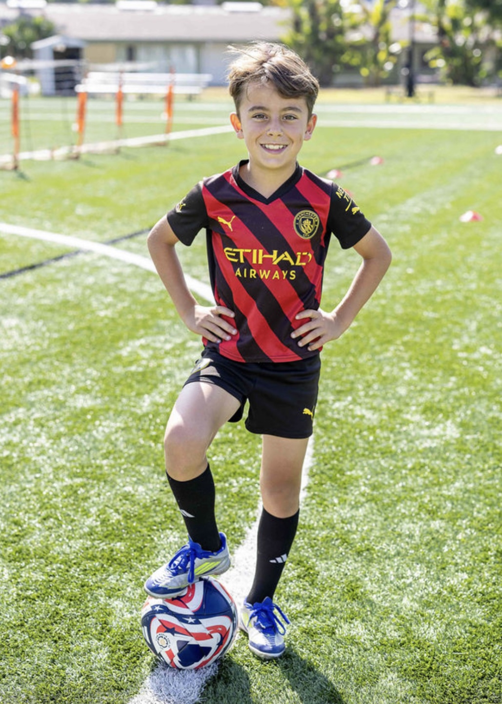 Young Soccer Player Standing with Ball to Promote Custom Mouthguard Protection