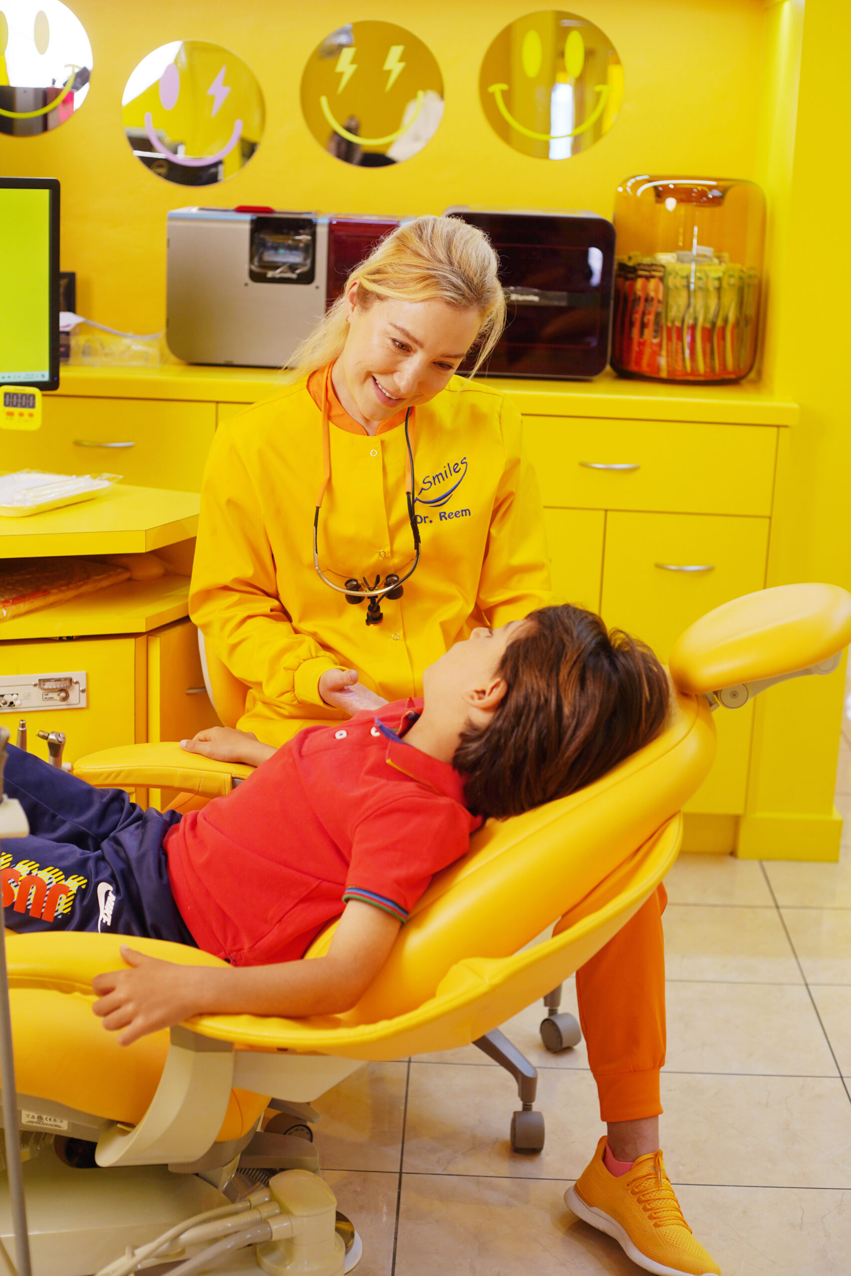 Pediatric Dentist Dr. Reem Consulting with Young Soccer Player